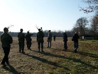 Another photo of militia members in a flat field