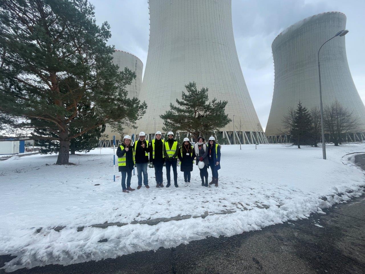 a group of students posing next to a nuclear reactor